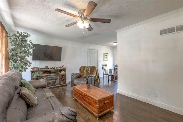 6606 E 135th St, Grandview, MO 64030 - living area featuring a textured ceiling, ceiling fan, wood finished floors, baseboards, and crown molding