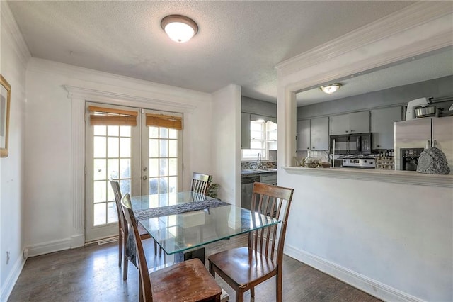 6606 E 135th St, Grandview, MO 64030 - dining area with french doors, a textured ceiling, baseboards, and ornamental molding
