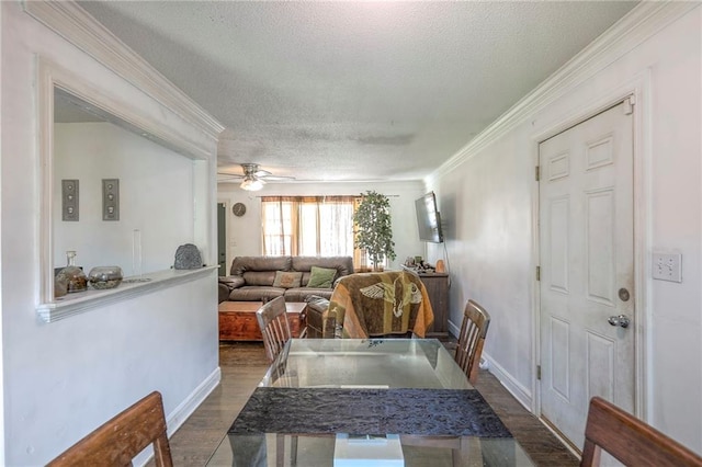6606 E 135th St, Grandview, MO 64030 - dining area with a textured ceiling, dark wood-style floors, crown molding, ceiling fan, and baseboards