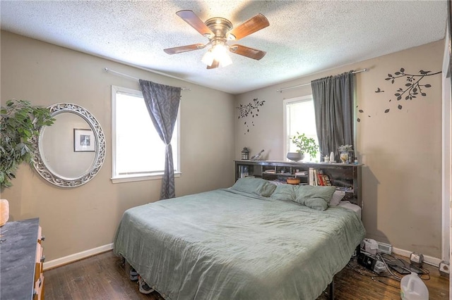 6606 E 135th St, Grandview, MO 64030 - bedroom with multiple windows, wood finished floors, baseboards, a textured ceiling, and a ceiling fan
