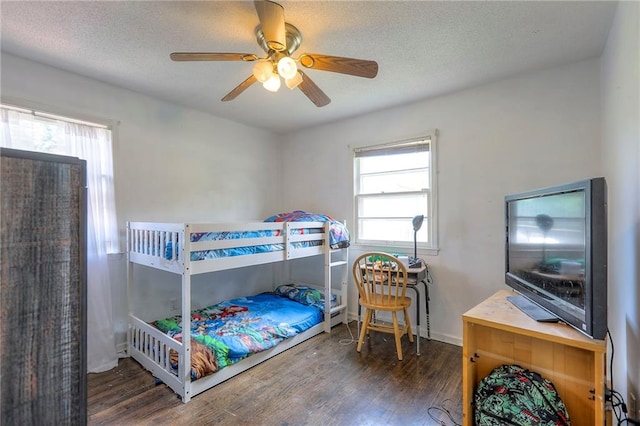 6606 E 135th St, Grandview, MO 64030 - bedroom with wood finished floors, multiple windows, a textured ceiling, and a ceiling fan