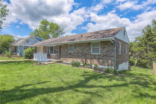 6606 E 135th St, Grandview, MO 64030 - view of front facade with a front lawn, brick siding, and an attached garage