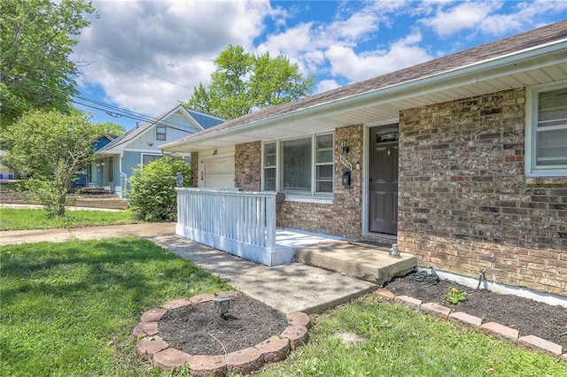 6606 E 135th St, Grandview, MO 64030 - entrance to property with brick siding, a garage, a porch, and a yard