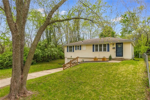 ranch-style house with a front yard, a garage, concrete driveway, and fence