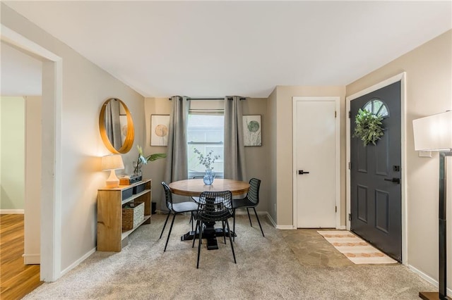 dining room featuring carpet floors and baseboards