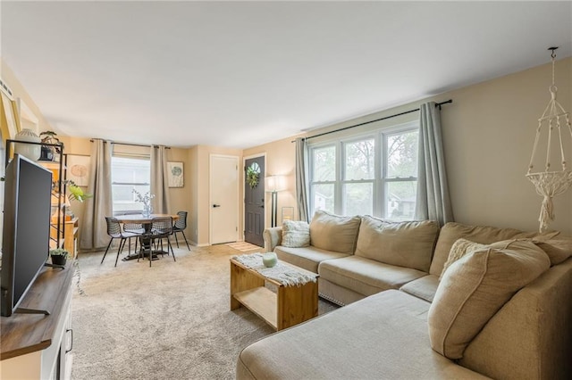 living room with a healthy amount of sunlight and light carpet