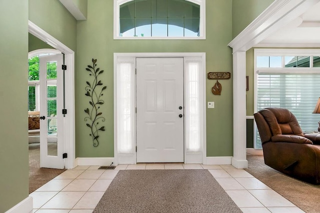 5720 NE Quartz Dr, Lees Summit, MO 64064 - entrance foyer featuring baseboards, visible vents, light tile patterned flooring, and a towering ceiling