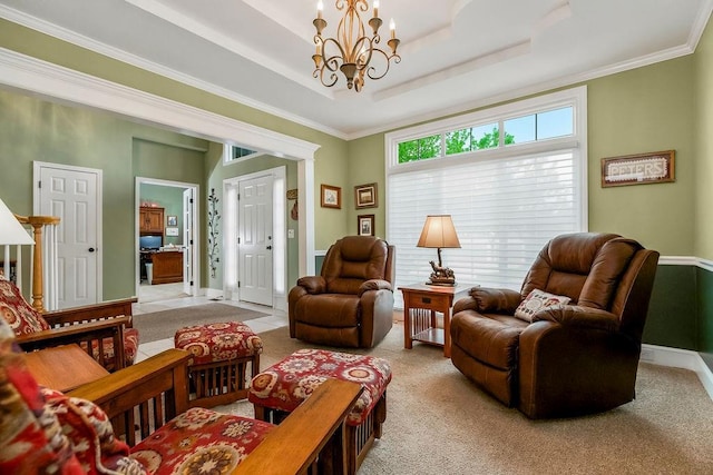 5720 NE Quartz Dr, Lees Summit, MO 64064 - living room with light colored carpet, ornamental molding, a tray ceiling, and a chandelier