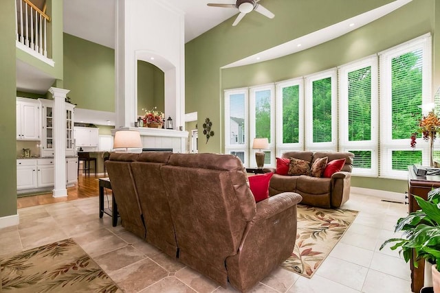 5720 NE Quartz Dr, Lees Summit, MO 64064 - living room featuring a ceiling fan, light tile patterned floors, and a towering ceiling