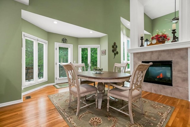 5720 NE Quartz Dr, Lees Summit, MO 64064 - dining room with visible vents, wood finished floors, a wealth of natural light, and a tile fireplace