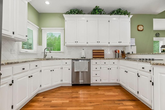 5720 NE Quartz Dr, Lees Summit, MO 64064 - kitchen featuring a sink, light stone counters, white cabinetry, and dishwasher
