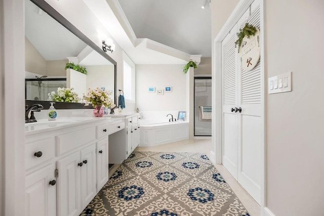 5720 NE Quartz Dr, Lees Summit, MO 64064 - full bath with tile patterned flooring, vanity, vaulted ceiling, a bath, and a stall shower