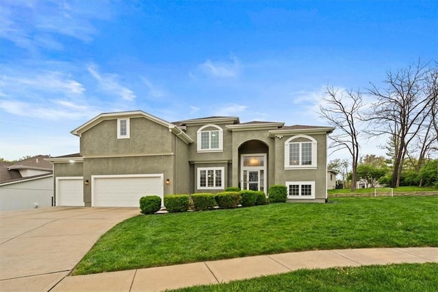 12544 Grand Ct, Kansas City, MO 64145 - view of front of home featuring a garage, a front lawn, driveway, and stucco siding
