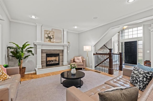 12544 Grand Ct, Kansas City, MO 64145 - living room with a tile fireplace, ornamental molding, wood finished floors, and recessed lighting