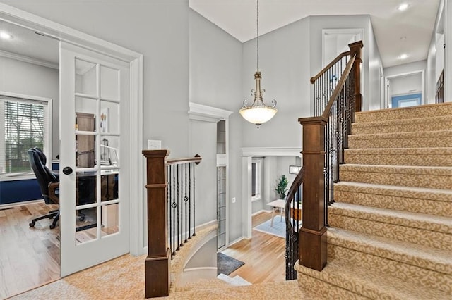 12544 Grand Ct, Kansas City, MO 64145 - stairs featuring a towering ceiling, wood finished floors, recessed lighting, and ornamental molding