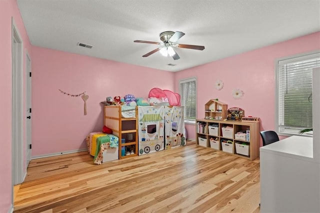 12544 Grand Ct, Kansas City, MO 64145 - bedroom with ceiling fan, wood finished floors, visible vents, and a textured ceiling