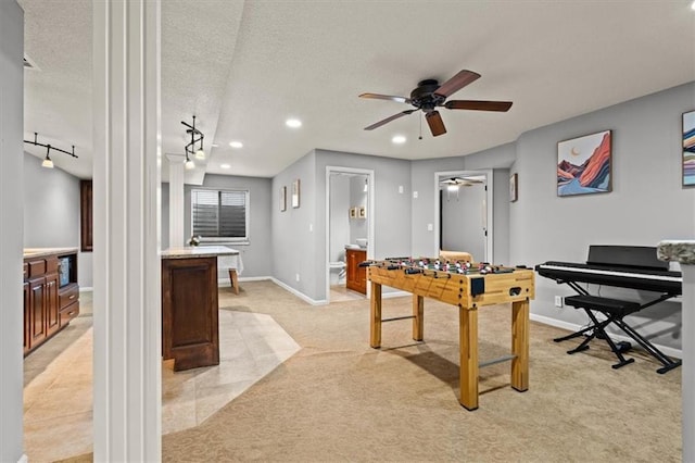 12544 Grand Ct, Kansas City, MO 64145 - game room with recessed lighting, ornate columns, a ceiling fan, light carpet, and baseboards