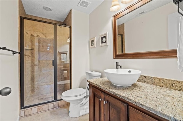 12544 Grand Ct, Kansas City, MO 64145 - full bathroom with tile patterned floors, a stall shower, vanity, toilet, and visible vents