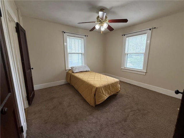 carpeted bedroom with baseboards, a ceiling fan, visible vents, and multiple windows