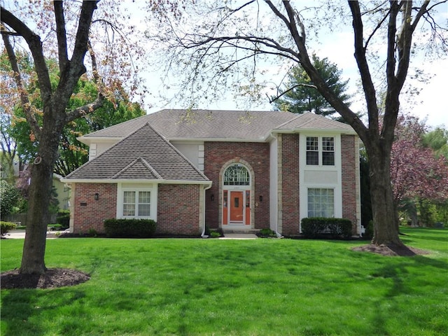 2405 W 123rd Ter, Leawood, KS 66209 - view of front facade featuring brick siding, roof with shingles, and a front yard