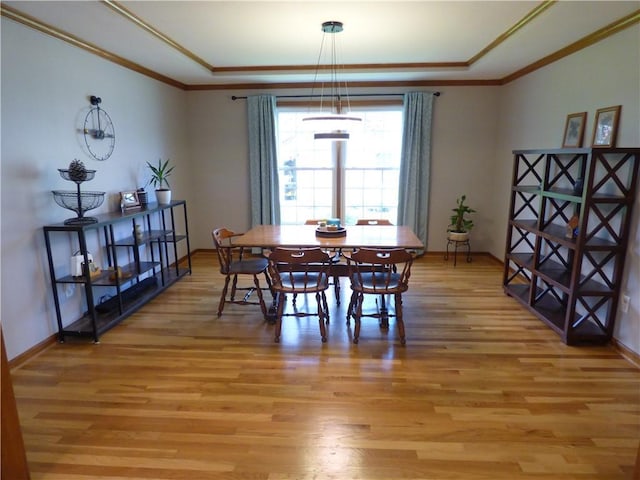 2405 W 123rd Ter, Leawood, KS 66209 - dining room featuring baseboards, ornamental molding, light wood finished floors, and a raised ceiling