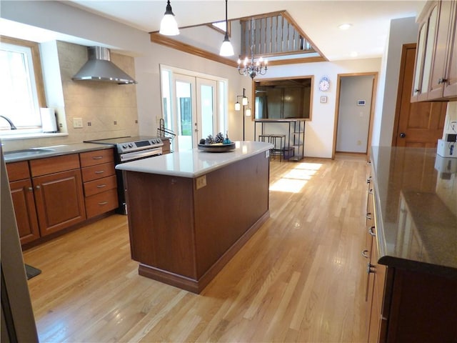 2405 W 123rd Ter, Leawood, KS 66209 - kitchen featuring wall chimney exhaust hood, a sink, stainless steel electric range, and light wood-type flooring