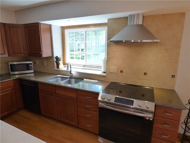 2405 W 123rd Ter, Leawood, KS 66209 - kitchen with wall chimney exhaust hood, a sink, tasteful backsplash, light wood-type flooring, and appliances with stainless steel finishes