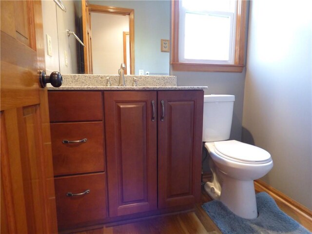 2405 W 123rd Ter, Leawood, KS 66209 - bathroom featuring wood finished floors, vanity, and toilet