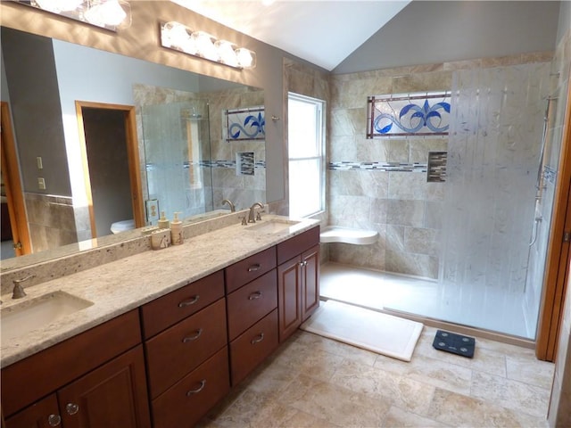 2405 W 123rd Ter, Leawood, KS 66209 - bathroom with double vanity, vaulted ceiling, a stall shower, and a sink