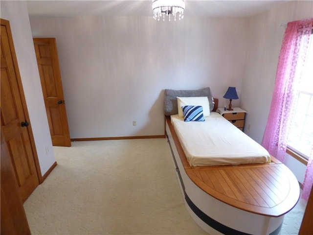 2405 W 123rd Ter, Leawood, KS 66209 - bedroom with light carpet, baseboards, and an inviting chandelier