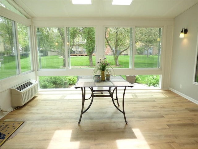 2405 W 123rd Ter, Leawood, KS 66209 - sunroom / solarium featuring a wall mounted air conditioner, ornamental molding, baseboards, and wood finished floors