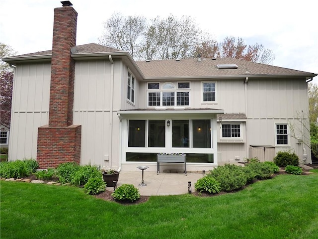 2405 W 123rd Ter, Leawood, KS 66209 - back of property with a lawn, a shingled roof, a chimney, and a patio