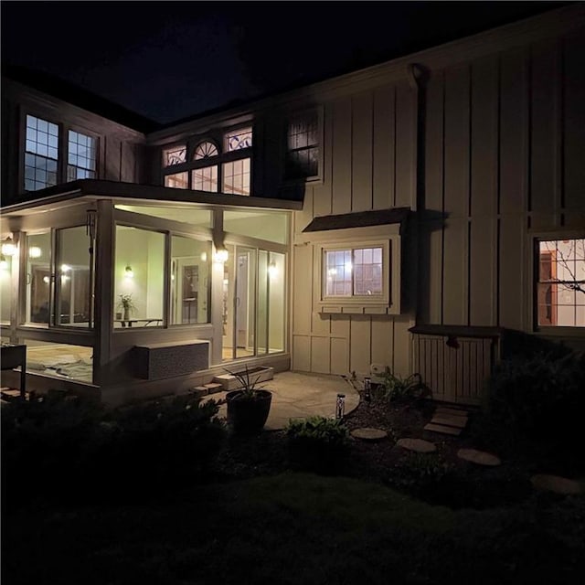 2405 W 123rd Ter, Leawood, KS 66209 - exterior entry at twilight featuring board and batten siding