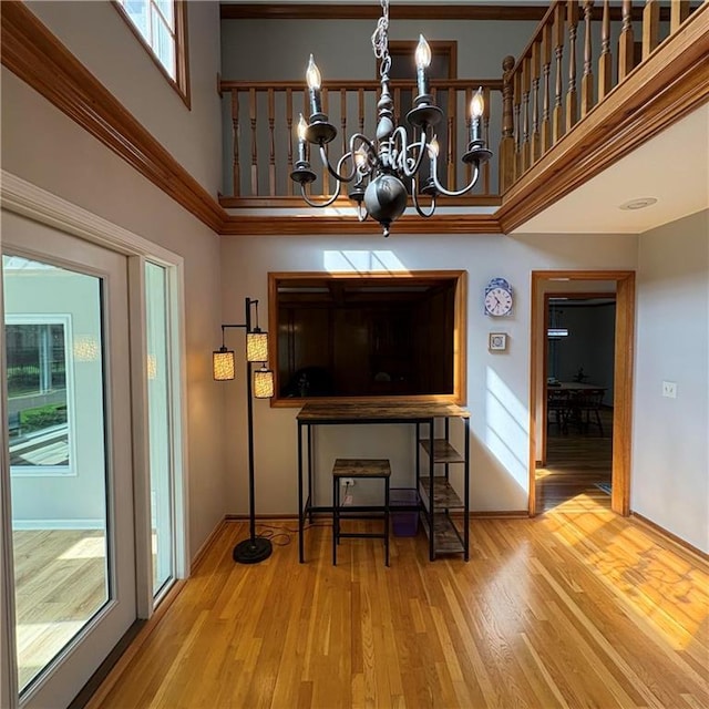 2405 W 123rd Ter, Leawood, KS 66209 - interior space with a notable chandelier, wood finished floors, a towering ceiling, and a healthy amount of sunlight