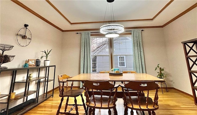 2405 W 123rd Ter, Leawood, KS 66209 - dining area featuring light wood-style floors, crown molding, baseboards, and a raised ceiling
