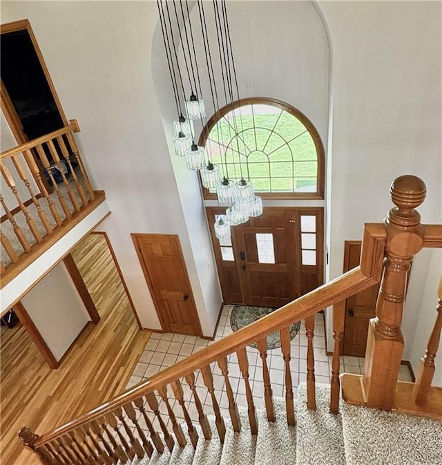 2405 W 123rd Ter, Leawood, KS 66209 - tiled entryway featuring arched walkways, stairway, and a towering ceiling