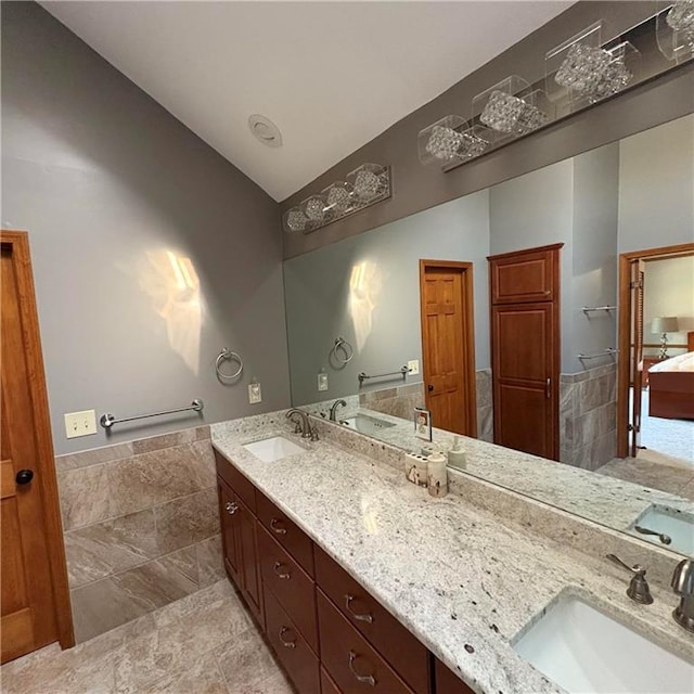 2405 W 123rd Ter, Leawood, KS 66209 - bathroom featuring lofted ceiling, a sink, and double vanity