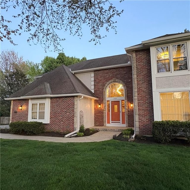 2405 W 123rd Ter, Leawood, KS 66209 - view of front of property with a front lawn, brick siding, and a shingled roof