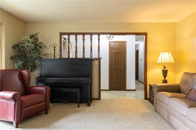interior space with baseboards, a textured ceiling, and light colored carpet