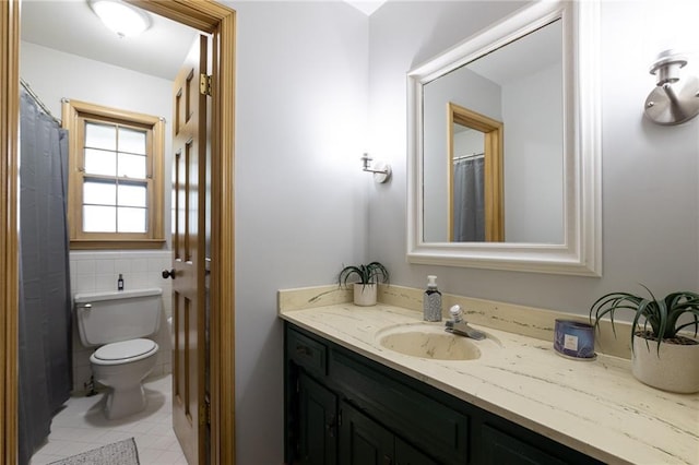 bathroom featuring toilet, tile patterned flooring, and vanity