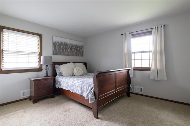 bedroom featuring light colored carpet, baseboards, and visible vents
