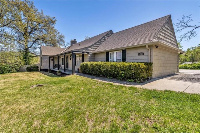 9501 Wornall Rd, Kansas City, MO 64114 - view of front of property with a front lawn, a chimney, and roof with shingles