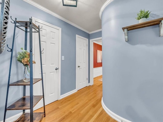 9501 Wornall Rd, Kansas City, MO 64114 - hallway featuring baseboards, ornamental molding, and light wood-style flooring