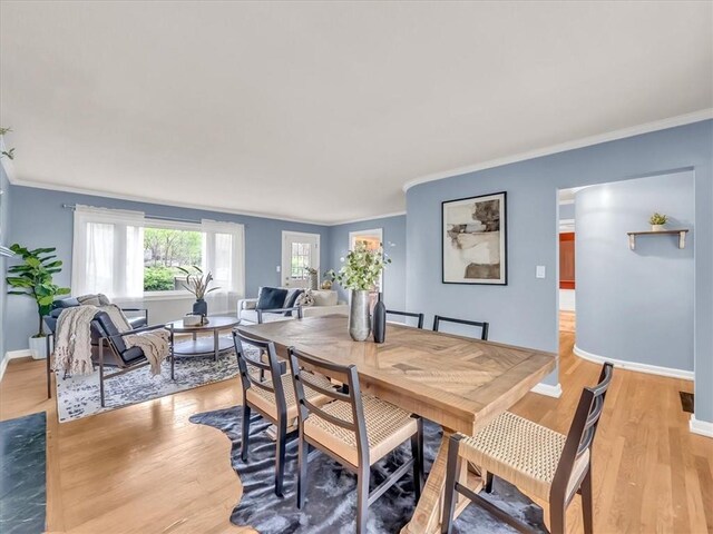 9501 Wornall Rd, Kansas City, MO 64114 - dining space featuring light wood-style flooring, baseboards, and crown molding