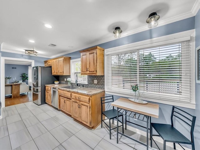 9501 Wornall Rd, Kansas City, MO 64114 - kitchen with ornamental molding, appliances with stainless steel finishes, tasteful backsplash, and a sink