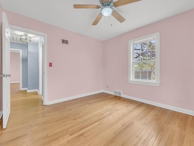 9501 Wornall Rd, Kansas City, MO 64114 - unfurnished room with light wood-type flooring, baseboards, visible vents, and ceiling fan