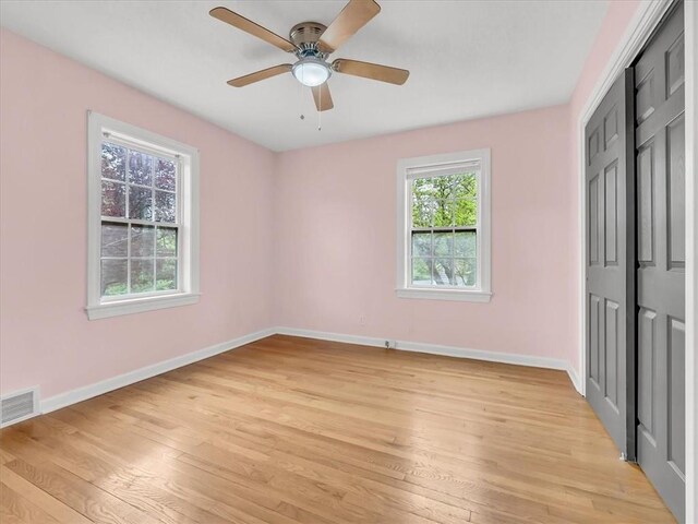 9501 Wornall Rd, Kansas City, MO 64114 - unfurnished bedroom with light wood-style flooring, baseboards, visible vents, a ceiling fan, and a closet