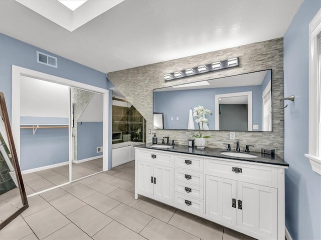 9501 Wornall Rd, Kansas City, MO 64114 - bathroom with double vanity, visible vents, tile patterned flooring, and a sink