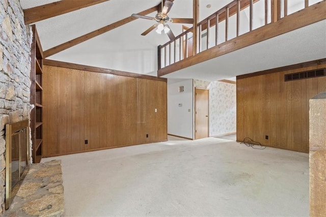 unfurnished living room featuring a ceiling fan, visible vents, a fireplace, high vaulted ceiling, and carpet flooring
