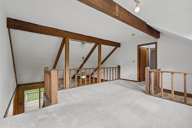 bonus room featuring carpet flooring, baseboards, and beam ceiling